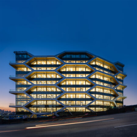 The Hive, Completed Exterior image at duck with the interior lights on and shining through the honeycomb facade