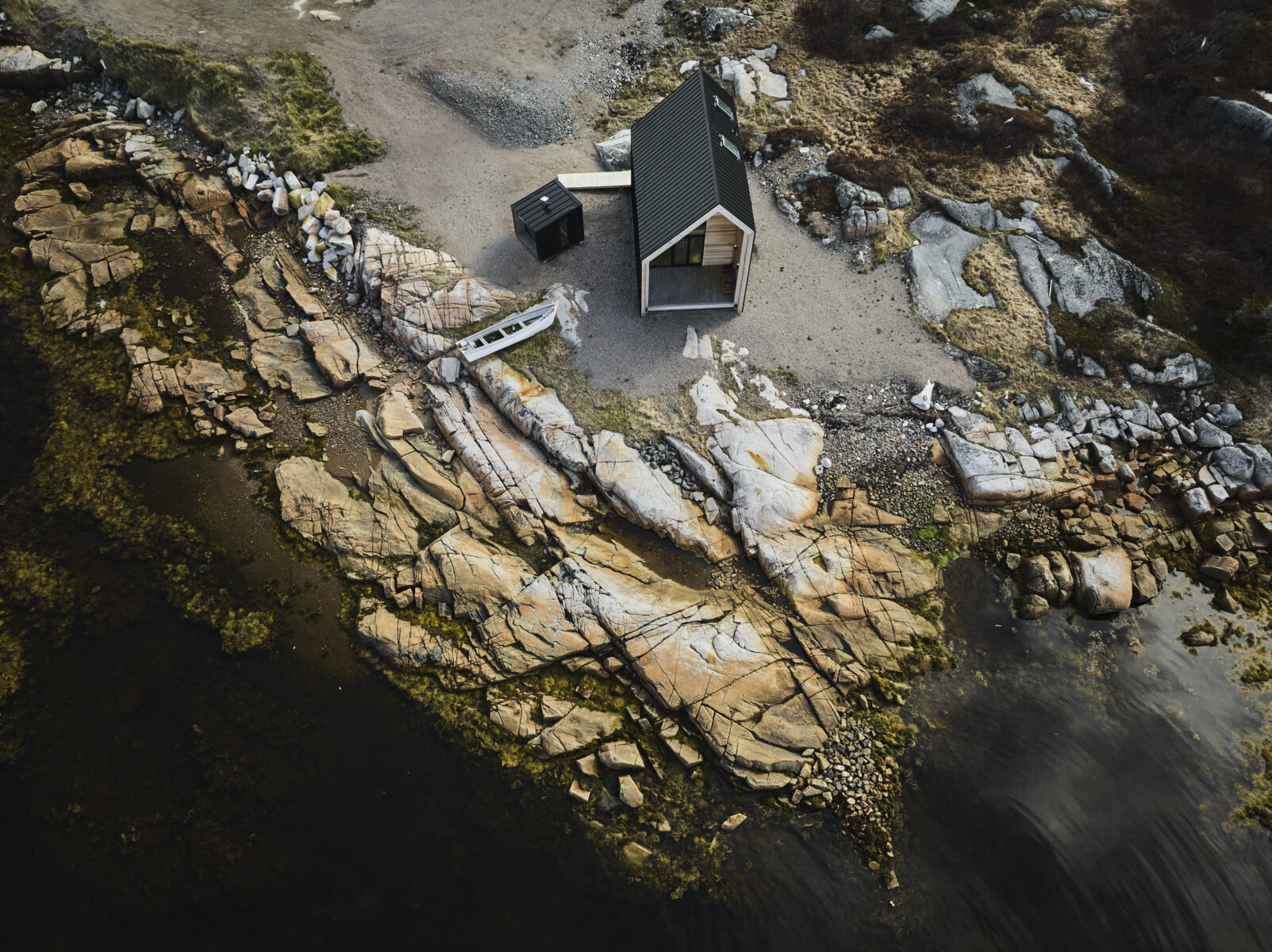 Aerial photo of an assembled Backcountry Huts Company cabin on Fogo Island, on the rocky coastline of Newfoundland