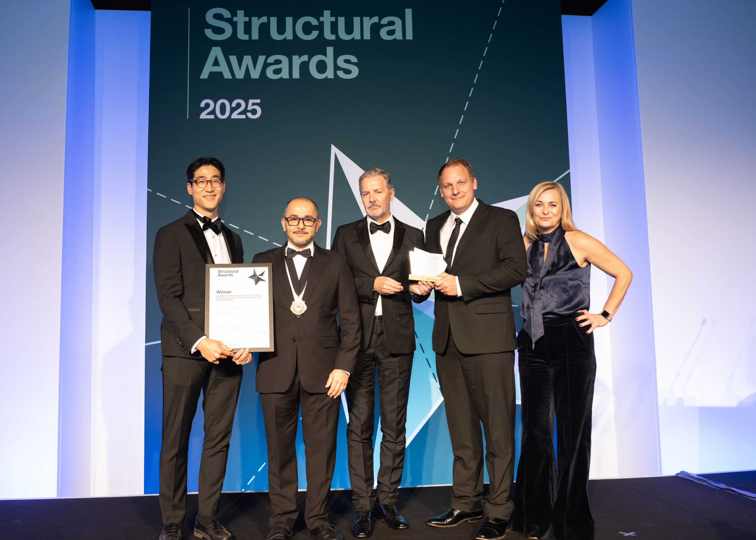 Fast + Epp Partner Robert Jackson, and guest Steve Jeon accept the iStructE Award for Limberlost Place at the awards gala in London