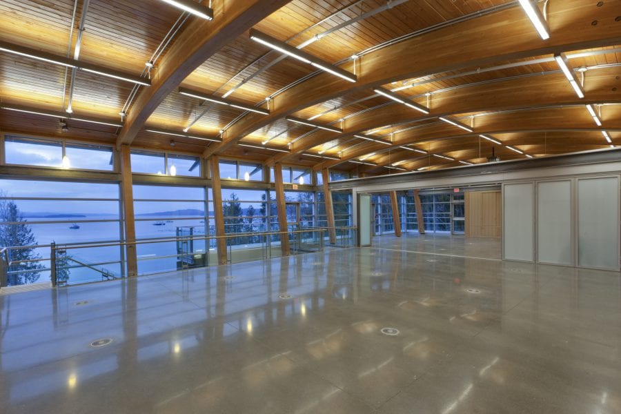 Interior image of University’s of Nanaimo Shellfish Research Centre's new field station in Bayne’s Sound. Shot shows lit the wood ceiling that spans the entire room.