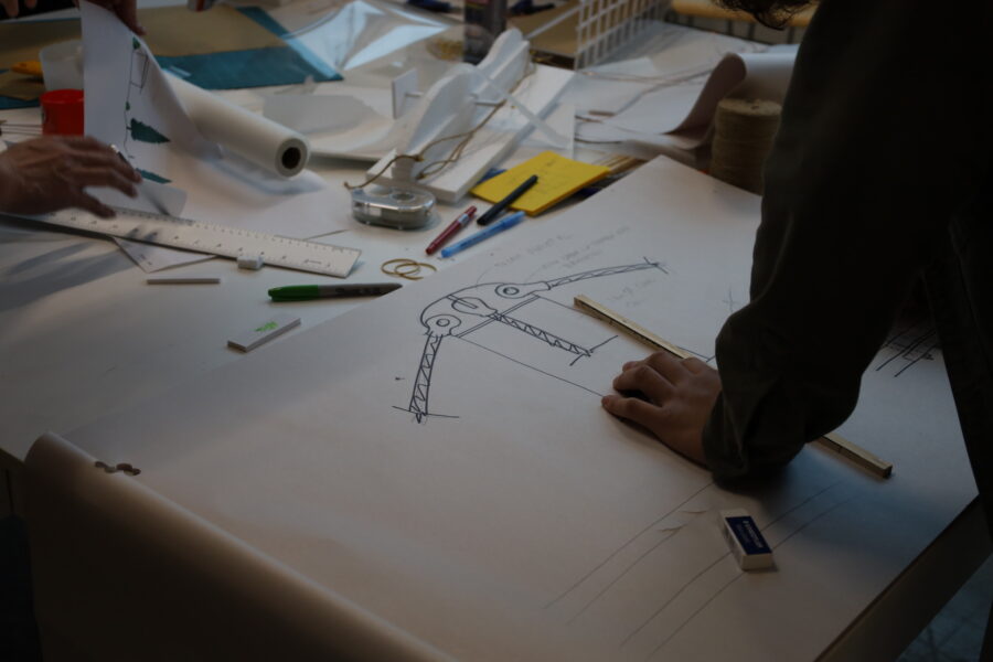 Architects and engineers collaborating on drafting design concepts during the workshop.