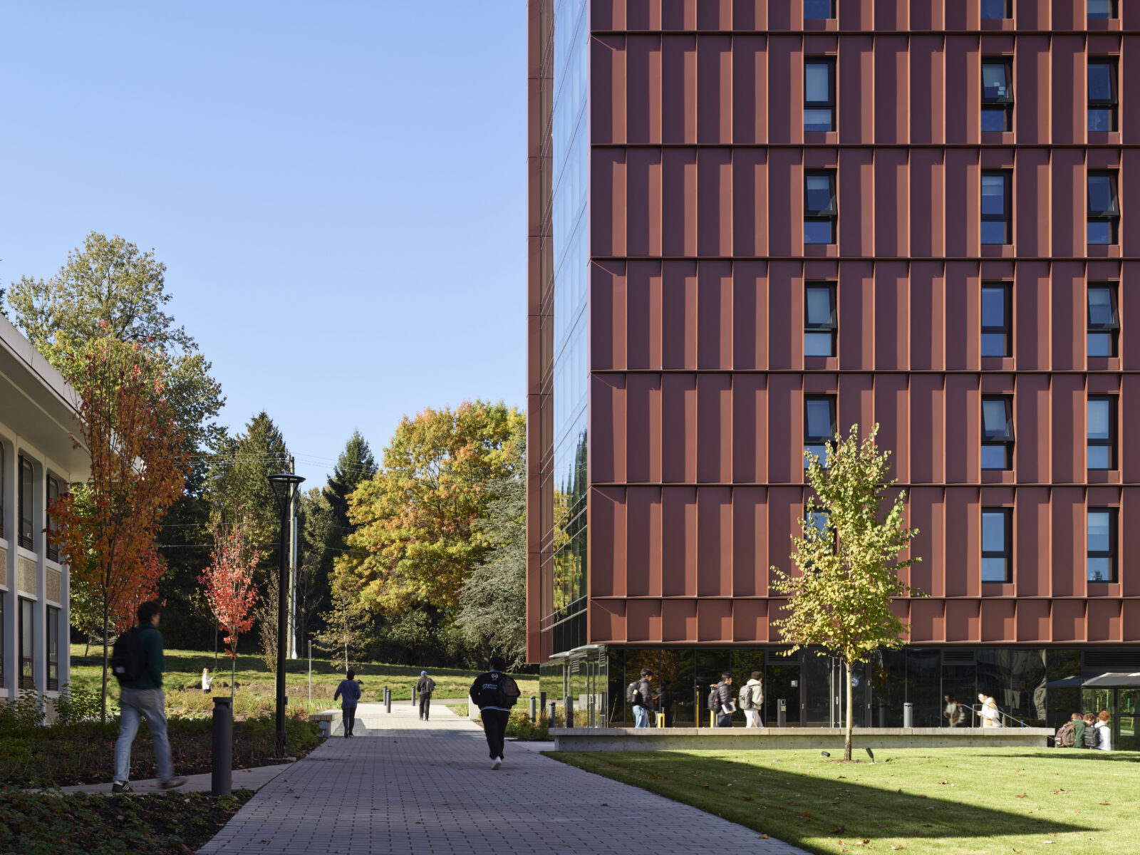 Completed exterior of BCIT Tall Timber Student Housing with students walking