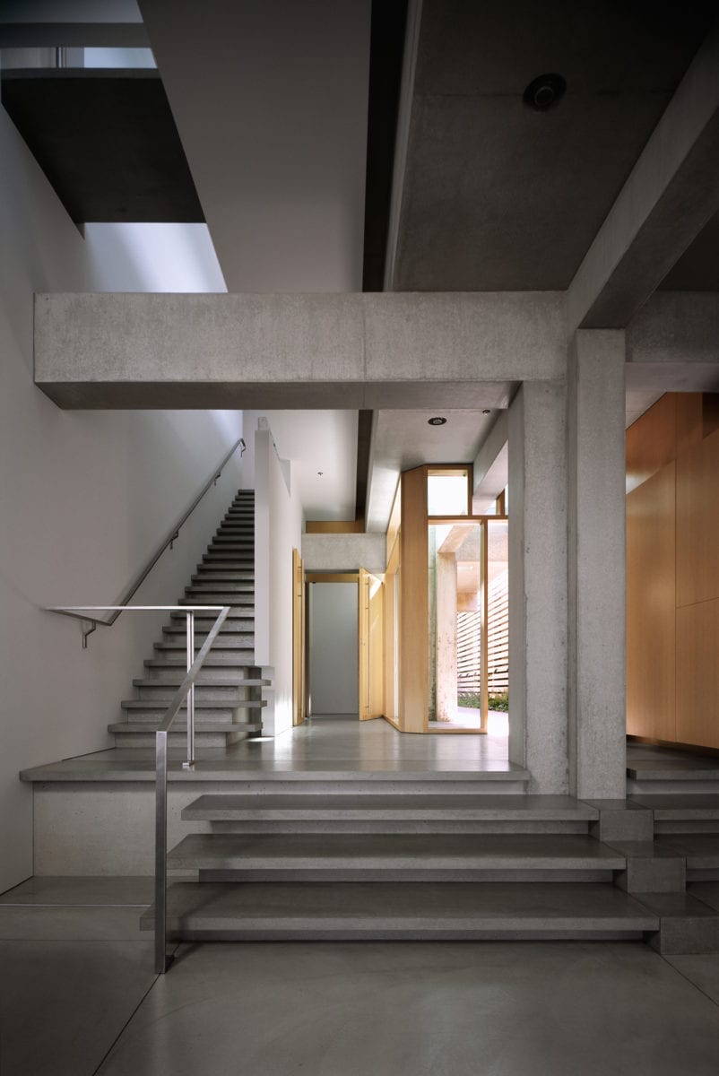 Interior entryway area of Shaw House, showing detailed exposed cast-in-place concrete and steel.