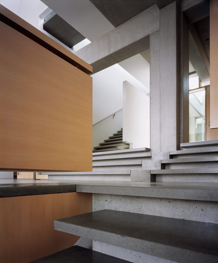 Interior close up shot of stairs in Shaw House, showing detailed exposed cast-in-place concrete and steel.